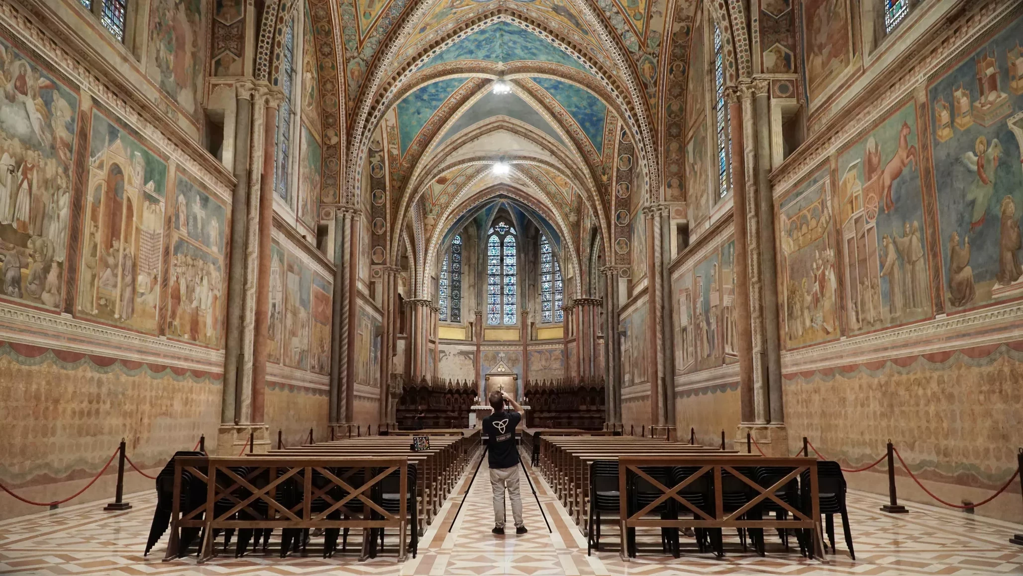 Nave of the Upper Basilica, with frescoed walls and painted vaults.
