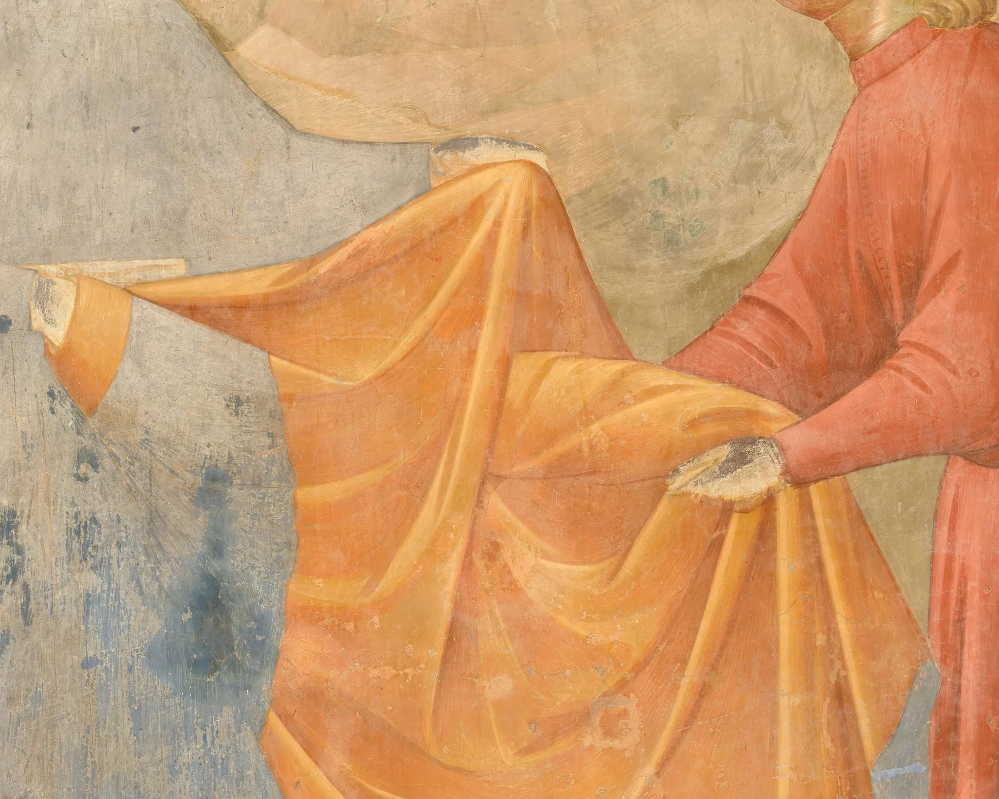Detail of the hands of Francis and the recipient holding the orange cloak.